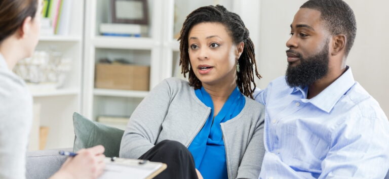 Couple meeting with a therapist to discuss couples therapy vs. marriage counseling